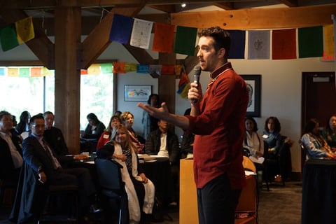 a person giving a speech in front of a group of people